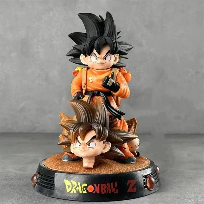 Kid Goku collectible statue with backpack and extra head on Dragon Ball Z base.