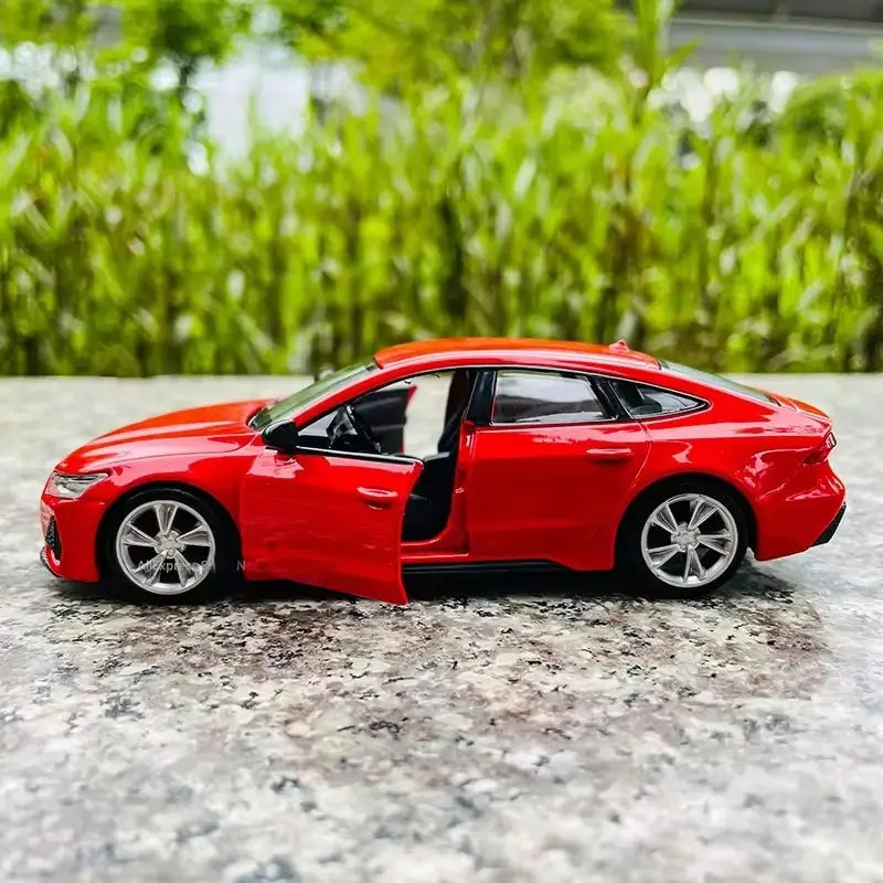 Red diecast Audi RS7 model car 1:35 scale with open door on marble surface outdoors