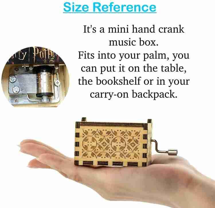 Mini hand crank music box fits in a palm, wooden carved design, size reference image