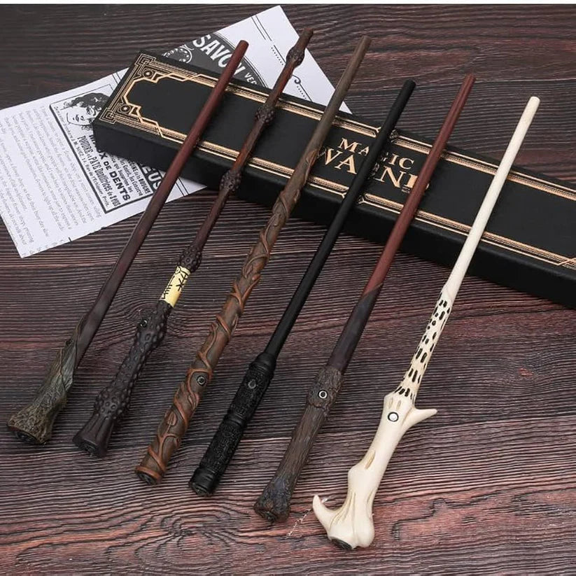 Set of decorative wands on a wooden surface with a box labeled 'MAGIC WAND' in the background.