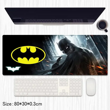 Batman desk mat with yellow Batman logo, dark city background, keyboard and mouse on table