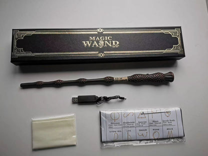 Magic wand with USB cable, cloth, and packaging on a gray surface